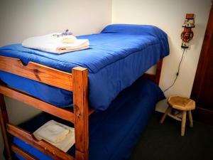 a bedroom with a bunk bed with blue sheets at Departamento Urbano in San Carlos de Bariloche