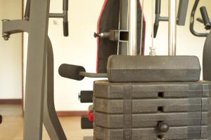 a gym with a stack of gym equipment at Olive Gardens Hotel Kampala in Kampala
