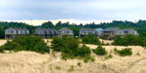 a row of houses on a beach in a field at Lighthouse Oceanfront Resort in Long Beach