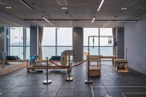 芽庄Moonlight Bay Panorama Condotel Ocean View的大房间设有玻璃窗,房间设有桌子