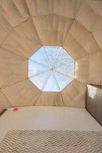 a room with a window in the middle of a tent at The Glamping Collective in Clyde