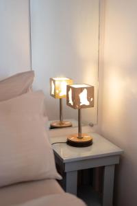 a pair of lamps on a table next to a bed at SMAK's Hotel in Bantayan Island