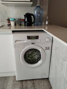 a white washing machine sitting in a kitchen at LuMar3 in Comodoro Rivadavia