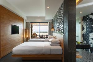 a bedroom with a large bed and a television at Renaissance Bali Uluwatu Resort & Spa in Uluwatu