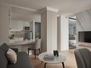 a living room with a couch and a table at The Alberti Hotel - Sukhumvit 31 in Bangkok