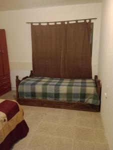 a bedroom with a bed with a plaid mattress at Alojamiento mendoza in Las Heras