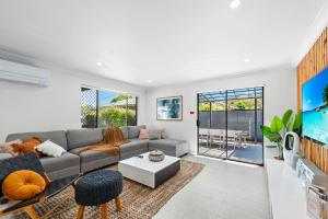 a living room with a couch and a table at Unit 2 11 Wentworth Avenue Nelson Bay in Nelson Bay
