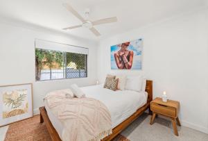 a bedroom with a bed and a ceiling fan at Unit 2 11 Wentworth Avenue Nelson Bay in Nelson Bay