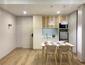 a kitchen and dining room with a table and chairs at Moon House BKK Room 3A in Bangna