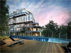 a large apartment building with a swimming pool next to it at Riverside Resort Apartment in Melbourne