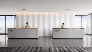 two men standing at reception desks in an office at Citadines Flatiron Phnom Penh in Phnom Penh