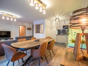 a dining room and living room with a wooden table and chairs at Appartement Valmorel, 3 pièces, 7 personnes - FR-1-356-415 in Valmorel