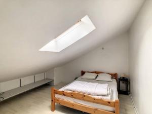 - une chambre avec un lit et une lucarne dans l'établissement Maison La Rochelle, 3 pièces, 4 personnes - FR-1-710-15, à La Rochelle