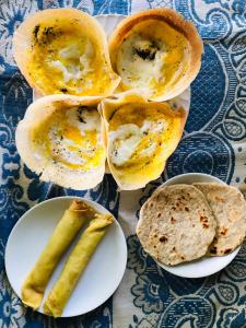 a plate of food with eggs and bread and a pickle at Green Horizon Ella in Ella