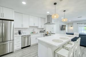 a kitchen with white cabinets and a white counter top at Blue Cove in Deerfield Beach