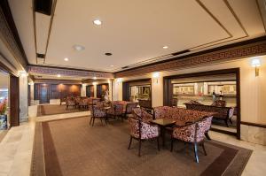 a restaurant with tables and chairs in a room at Diamond Plaza Hotel in Hat Yai