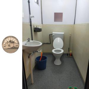 a bathroom with a toilet and a sink at Tanah Merah Glamping Village (TMGV) in Kuala Kangsar