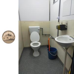 a bathroom with a toilet and a sink at Tanah Merah Glamping Village (TMGV) in Kuala Kangsar