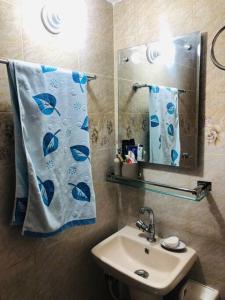 a bathroom with a sink and a mirror at Home Away From Home in Chittagong