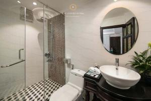 a bathroom with a sink and a mirror at Maya boutique Hotel HN - by BAY LUXURY in Hanoi +20 photos