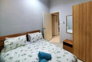 a bedroom with a bed with a blue pillow on it at Doma House Alpine at Lost World of Tambun in Tambun
