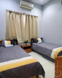 a bedroom with two beds and a window at Doma House Alpine at Lost World of Tambun in Tambun