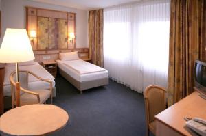 Postel nebo postele na pokoji v ubytování Hotel Wetterau - Self-Check-In