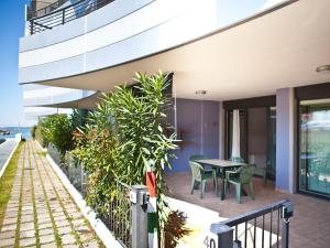 a balcony of a house with a table and chairs at Costa Azzurra Residence in Grado