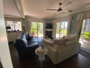 a living room with two couches and a fireplace at House of Mahalo BnB in Mapleton