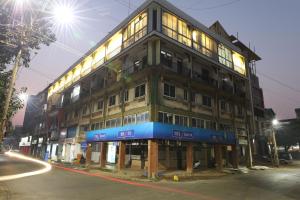 a large building on a city street at night at Teles Westend Hotel in Marmagao