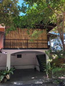 a garage with a wooden deck on top of it at Drop Hostel in Kandy