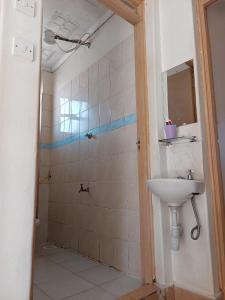 W łazience znajduje się umywalka i prysznic. w obiekcie sky furnished apartment in south b w mieście Nairobi