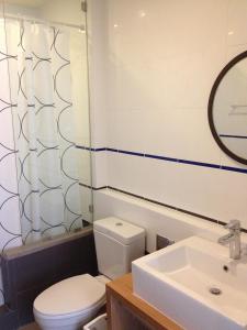 a bathroom with a toilet and a sink and a mirror at บ้านแสนคราม หัวหิน Family Room - Pool Access ห้องติดสระ in Phetchaburi