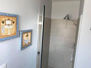 a bathroom with a shower and a picture on the wall at SPACE X ,LAX & Beaches Beautiful Guest House in Gardena