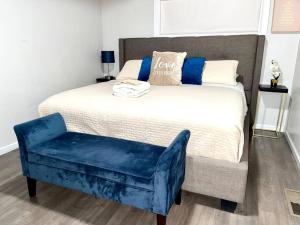 a bedroom with a bed with a blue chair at SPACE X ,LAX & Beaches Beautiful Guest House in Gardena
