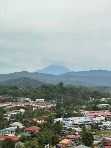 a city with buildings and mountains in the background at Blest Loft 12 Manhattan Suites ITCC in Penampang