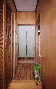 a hallway with a door and a potted plant at Osaka MISAKI Traditional Japanese house 2-6 ppl near station in Osaka