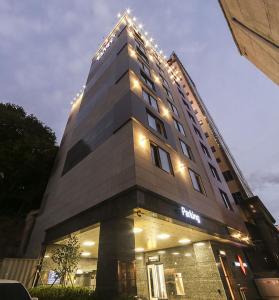 a tall building with lights on top of it at Maron Hotel Nampo in Busan