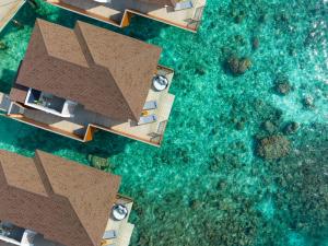 an aerial view of a resort with blue water at Avani Plus Fares Maldives Resort in Baa Atoll