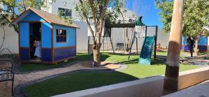 a small playground with a tree and a play structure at Casa Mauricio in La Paz