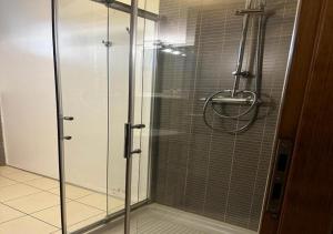 a shower with a glass door in a bathroom at Residence La Settima in Milano Marittima