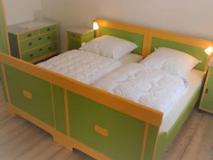 a bedroom with a large bed with a wooden frame at Idyllische Ferienwohnung auf altem Bauernhof in Emmerthal