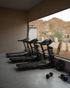 a row of gym chairs sitting next to a window at Sahary Al Ula Resort in AlUla