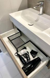 a bathroom with a sink and a black hair dryer at Luxury 2 bedrm apartment in Broadbeach- Be a Star in Tower One of the casino 2 bedroom apartment 334F in Gold Coast