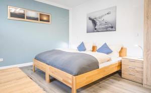 a bedroom with a bed with blue walls and a wooden bed frame at Weisses Rössl in Pfreimd