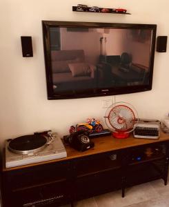 a table with a tv and a record player on it at La Guta Studio Suite Jerusalem in Jerusalem