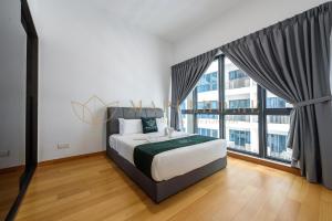 ein Schlafzimmer mit einem Bett und einem großen Fenster in der Unterkunft The Colony and The Luxe Premier Suites Kuala Lumpur in Kuala Lumpur