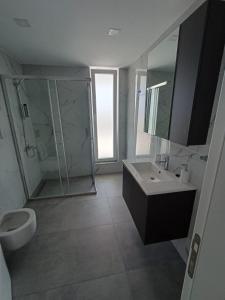 a bathroom with a sink and a shower and a toilet at Courtyard Long Beach Holiday Resort in Iskele