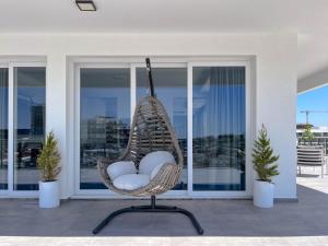 a wicker chair sitting in front of a house at Courtyard Long Beach Holiday Resort in Iskele