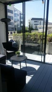a patio with a table and chairs on a balcony at Spacious super located Lahti apartment in Lahti